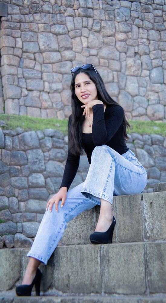 Mujer sonriendo sentada en una escalinata de piedra